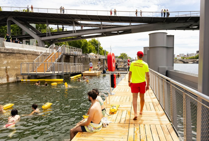 Swimmers and lifeguards by Seine river
